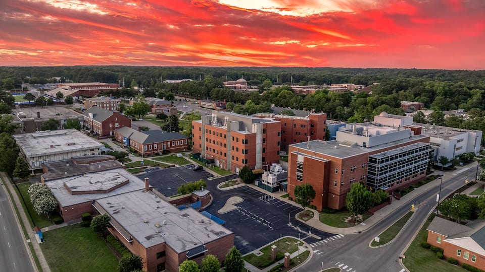 Aerial view of Fayetteville state university historically black college administration building with dramatic colorful sunset sky