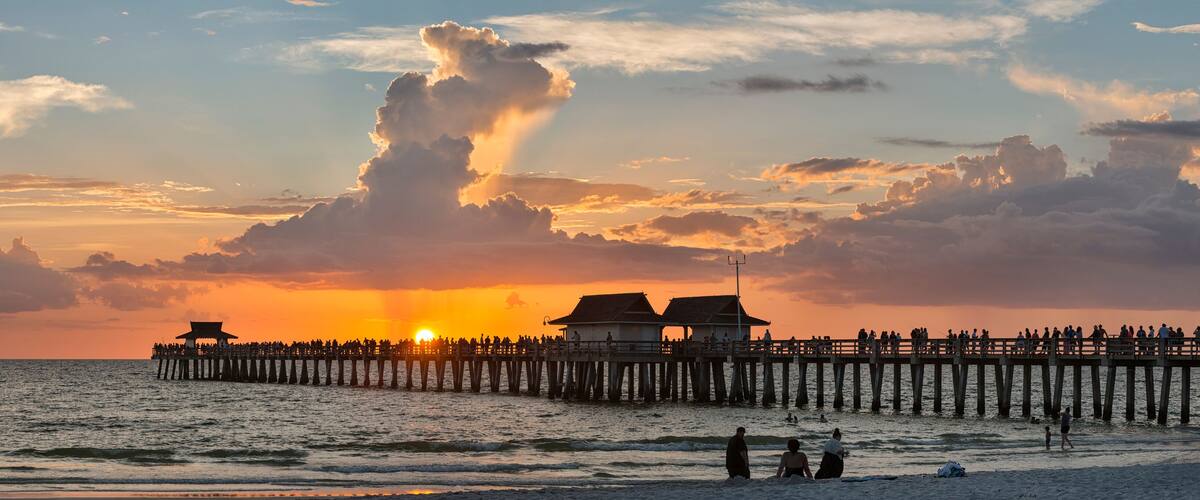 USA, Florida, Naples, panoramic view of Naples Pier with crowd enjoying sunset