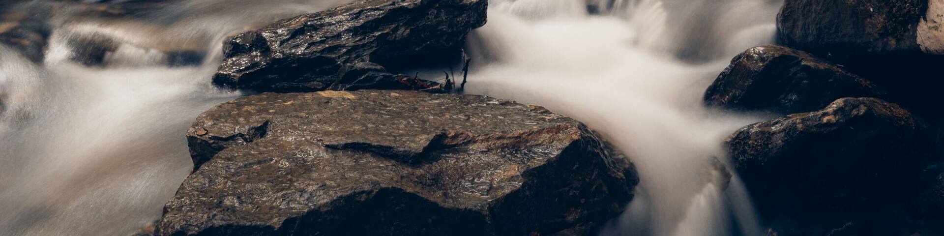 A waterfall surrounded by autumn foliage.