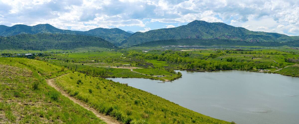 Bear Creek Lake - A panoramic Spring view of a biking trail winding at side of Mt. Carbon, overlooking Bear Creek Lake. Bear Creek Lake Park, Denver-Lakewood, Colorado, USA.