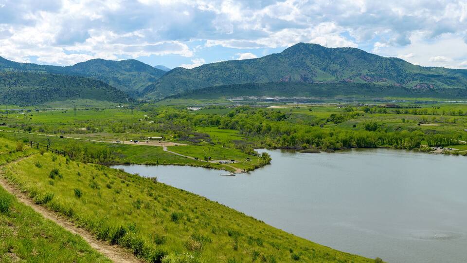 Bear Creek Lake - A panoramic Spring view of a biking trail winding at side of Mt. Carbon, overlooking Bear Creek Lake. Bear Creek Lake Park, Denver-Lakewood, Colorado, USA.
