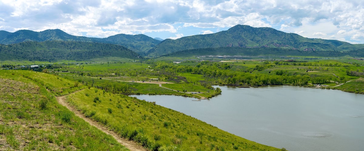A river winding through a valley with mountains in the background.