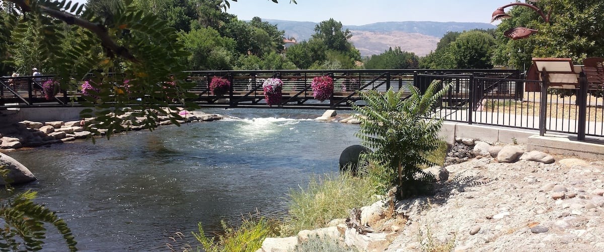 This picturesque River Walk features beautiful flowers that adorn the walking bridge. It is surrounded by a dense wooded area that's framed by the peaks of the Truckee River's mountain range. 
#LifeAtExpedia