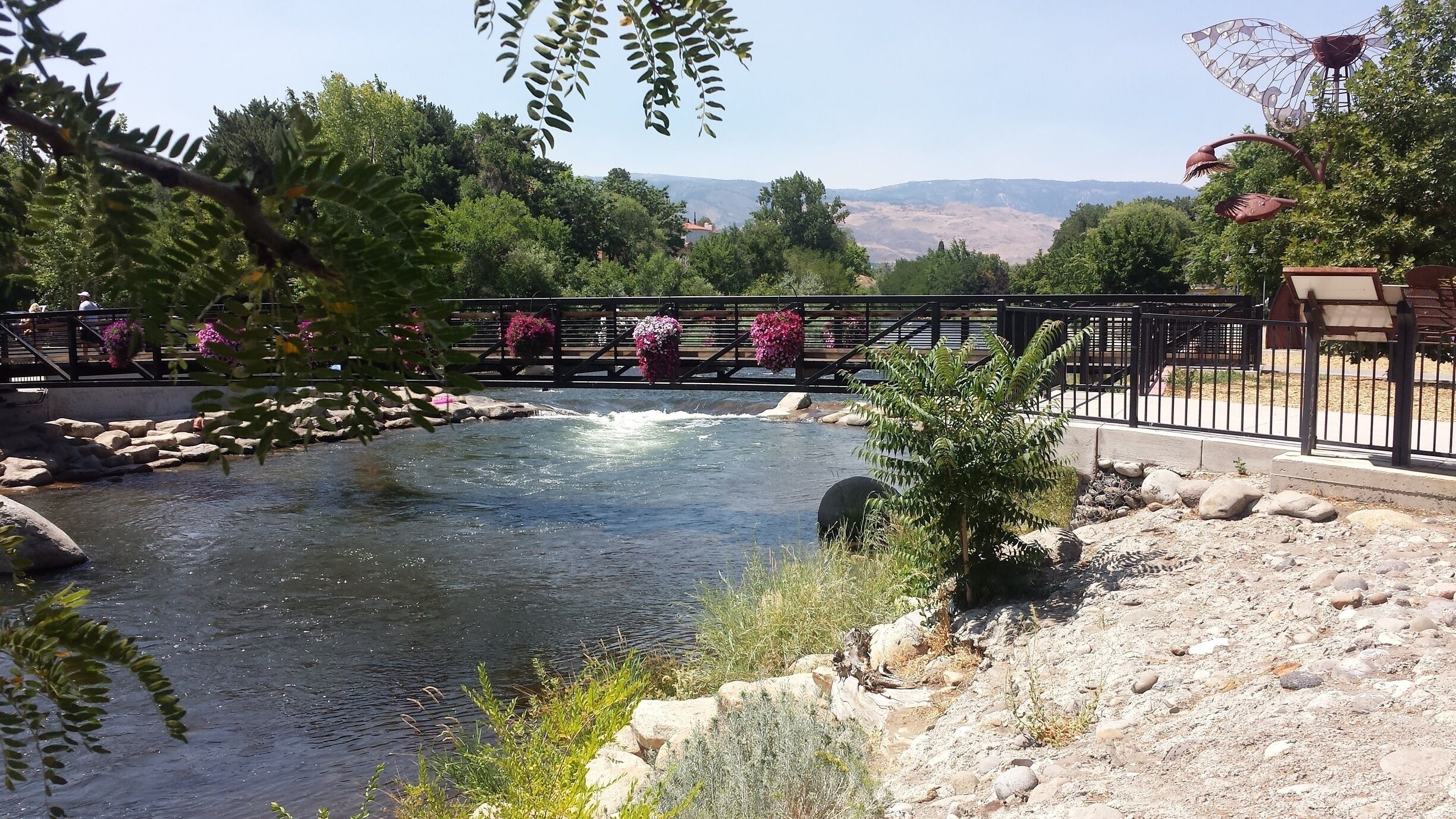 This picturesque River Walk features beautiful flowers that adorn the walking bridge. It is surrounded by a dense wooded area that's framed by the peaks of the Truckee River's mountain range. 
#LifeAtExpedia 