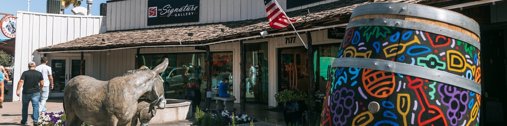 Arts District which includes a statue or sculpture, outdoor art and flowers