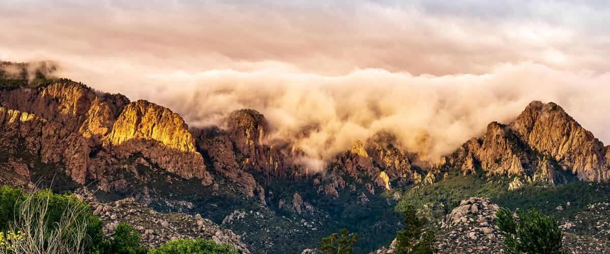 Panoramic of the Sandia mountains captured at sunset and a fog in Albuquerque, New Mexico