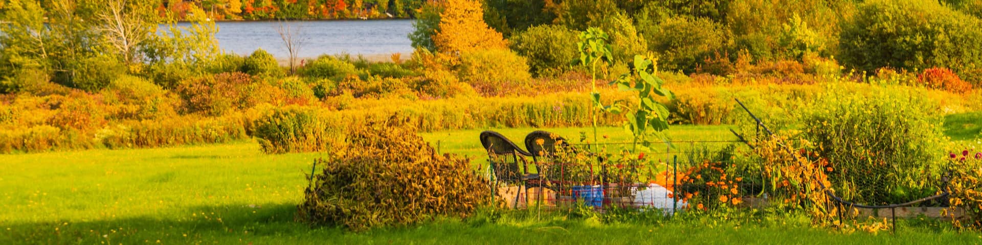 Lake Iroquois surrounded by forests in brilliant fall foliage colors with Camel's Hump Mountain in the distance