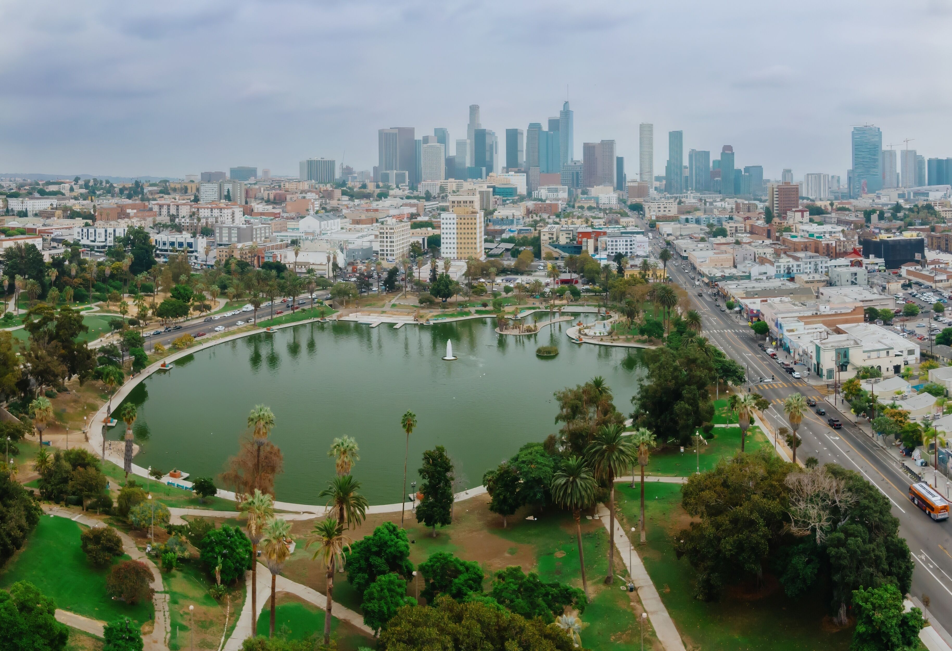 MacArthur Park in Los Angeles, California, USA, offers a green space for recreation and relaxation amidst the urban landscape. The downtown skyline rises in the background.
