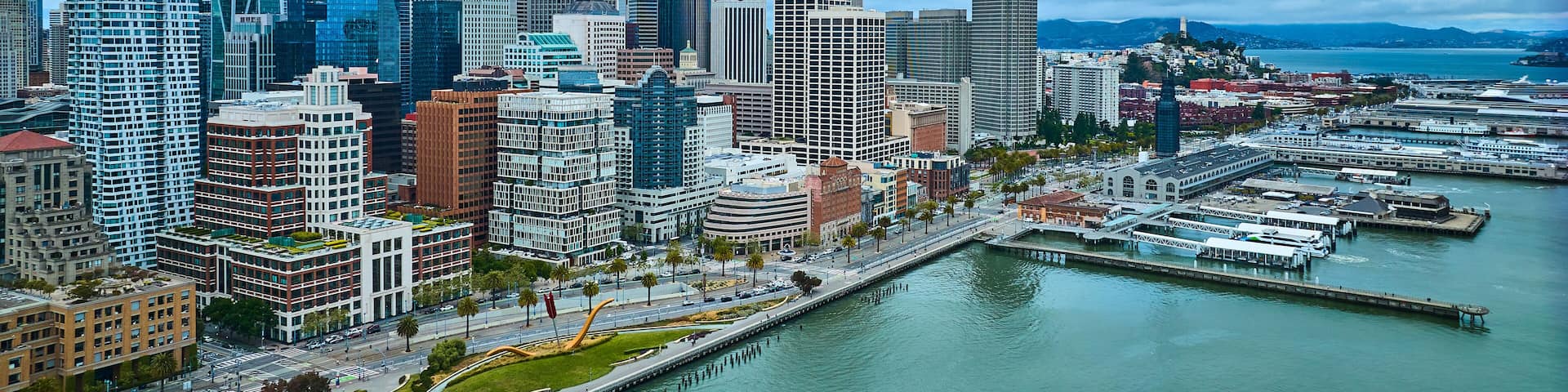 San Francisco city aerial The Embarcadero bayside view with docs and downtown skyscrapers, CA
