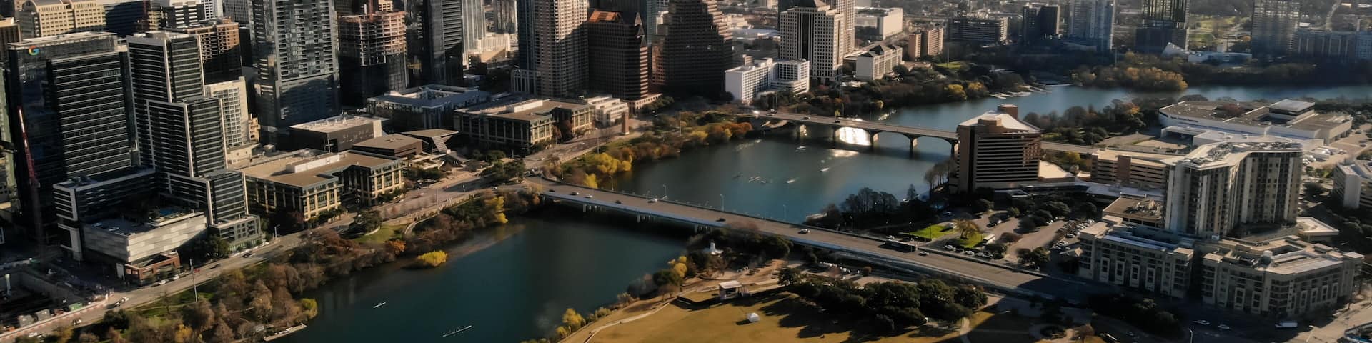 A cityscape with a river, bridges, and modern buildings.