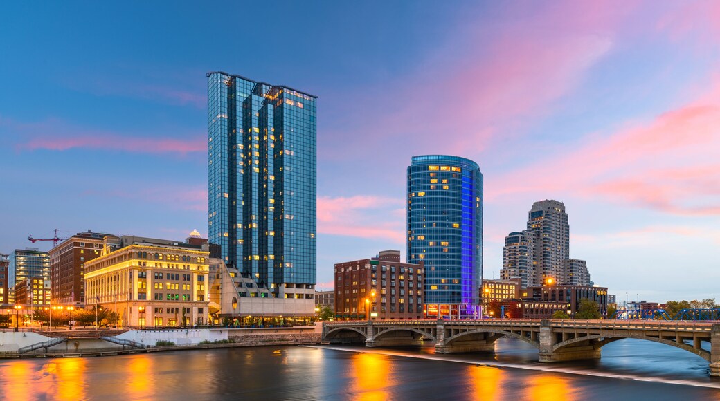 A cityscape with modern skyscrapers, a river, and a bridge.
