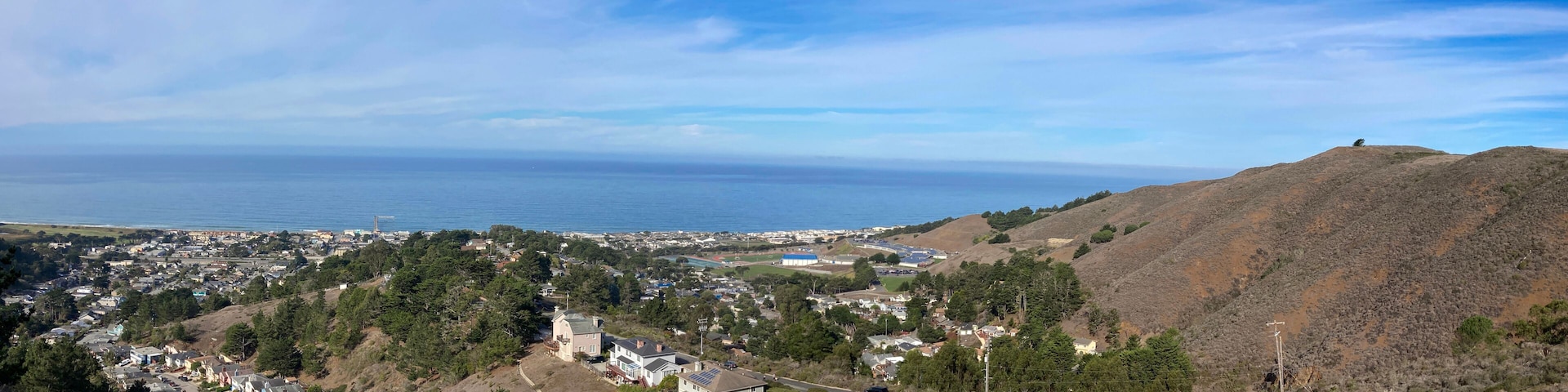 Scenic aerial panoramic view of Sharp Park residential neighborhood and Milagra Ridge in Pacifica, California from Pacifica Vista Point at Sharp Park Road.