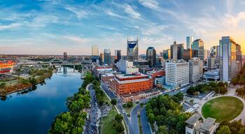 Panoramic view of Nashville skyline at sunset with river, skyscrapers, and city landmarks