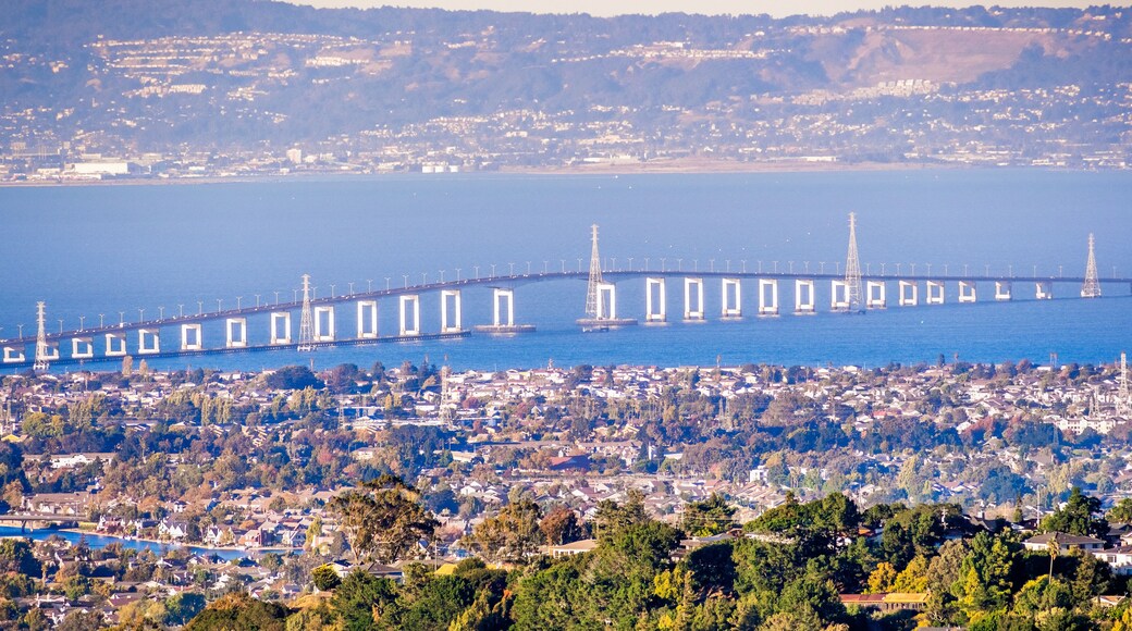 Aerial view of San Mateo Bridge, connecting the Peninsula and East Bay; residential areas of Foster City visible in the foreground ; San Francisco Bay Area, California