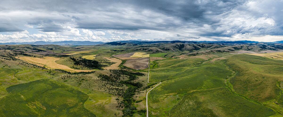 Stormy southwest Montana foothills farmland patchwork panorama - Gallatin Valley - Spanish Peaks - Rocky Mountains