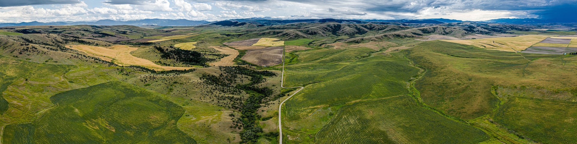 Stormy southwest Montana foothills farmland patchwork panorama - Gallatin Valley - Spanish Peaks - Rocky Mountains