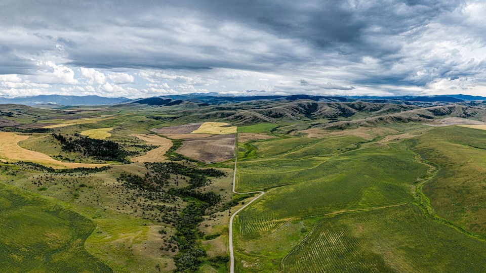 Stormy southwest Montana foothills farmland patchwork panorama - Gallatin Valley - Spanish Peaks - Rocky Mountains