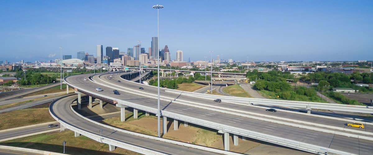 Panorama aerial view Houston downtown and interstate 69 highway with massive intersection, stack interchange and elevated road junction overpass at early morning from the northeast side of Houston, US