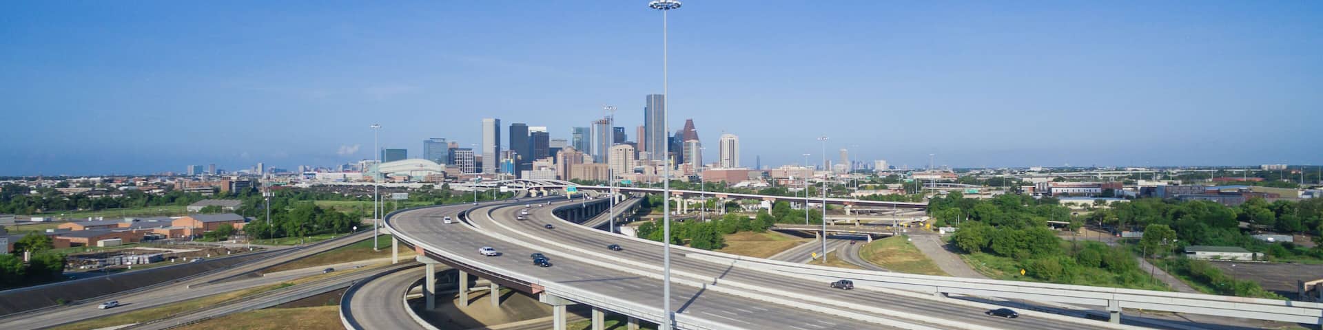 Panorama aerial view Houston downtown and interstate 69 highway with massive intersection, stack interchange and elevated road junction overpass at early morning from the northeast side of Houston, US