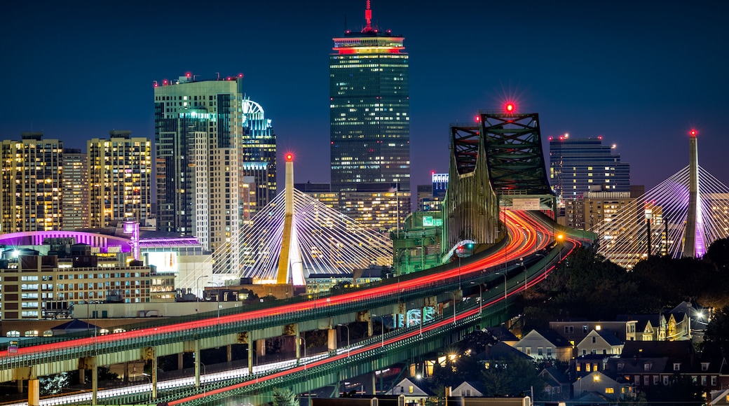 Rush hour traffic on Tobin bridge (aka Mystic River bride) heading towards Zakim bridge and Boston skyline by night