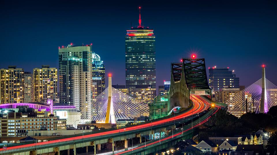 Rush hour traffic on Tobin bridge (aka Mystic River bride) heading towards Zakim bridge and Boston skyline by night