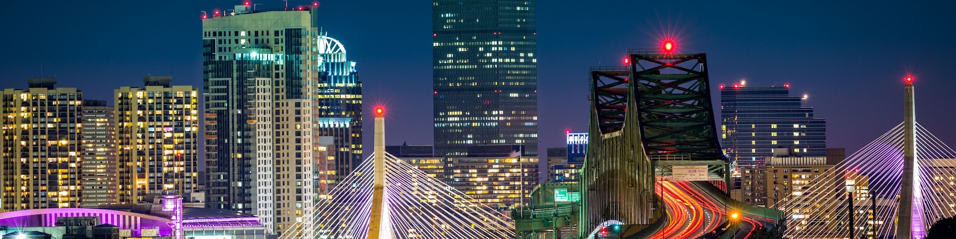 Rush hour traffic on Tobin bridge (aka Mystic River bride) heading towards Zakim bridge and Boston skyline by night