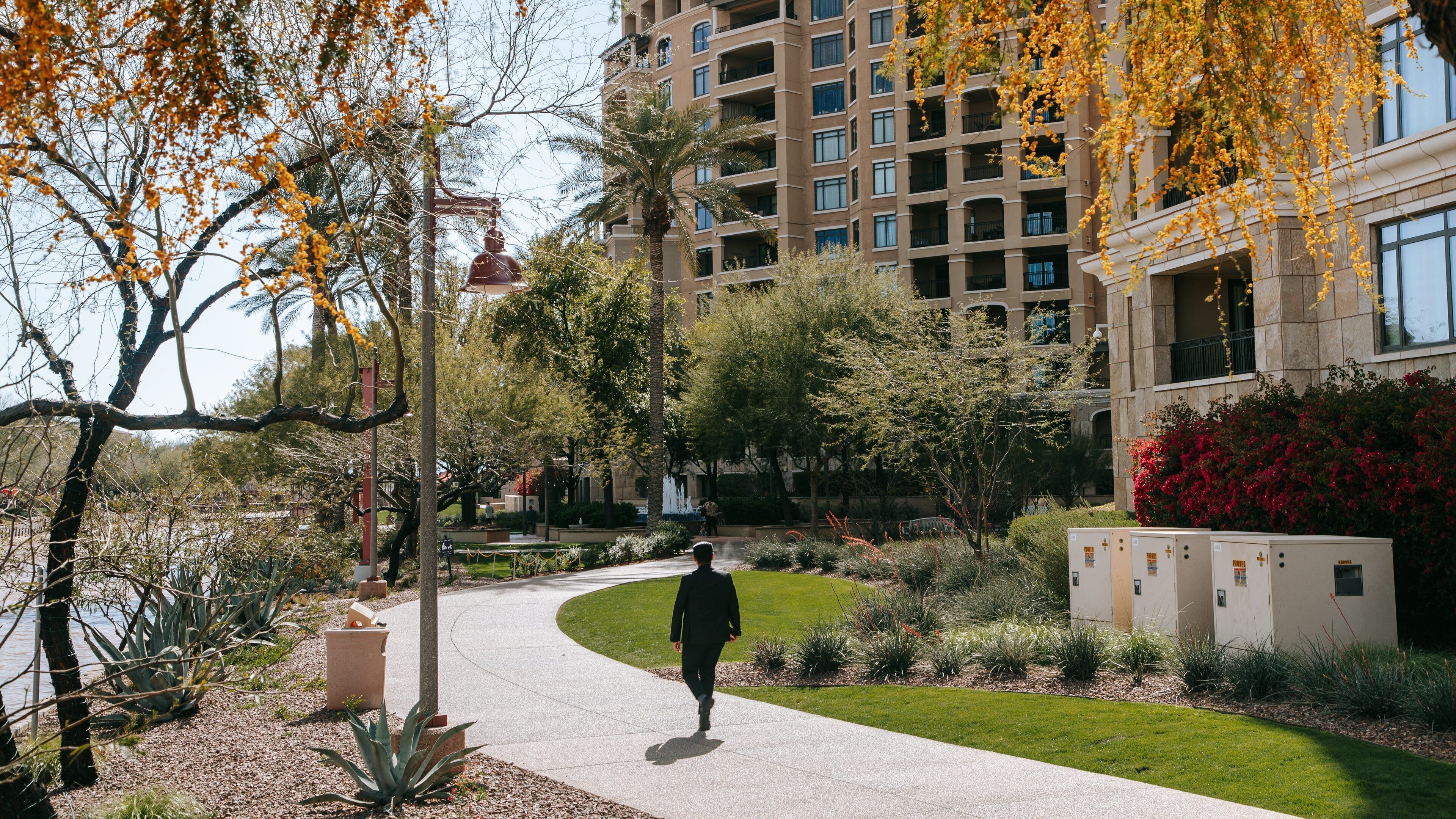 Downtown Scottsdale featuring a garden as well as an individual male