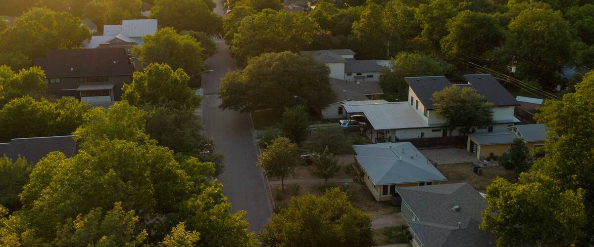 Crestview featuring a sunset, landscape views and a small town or village