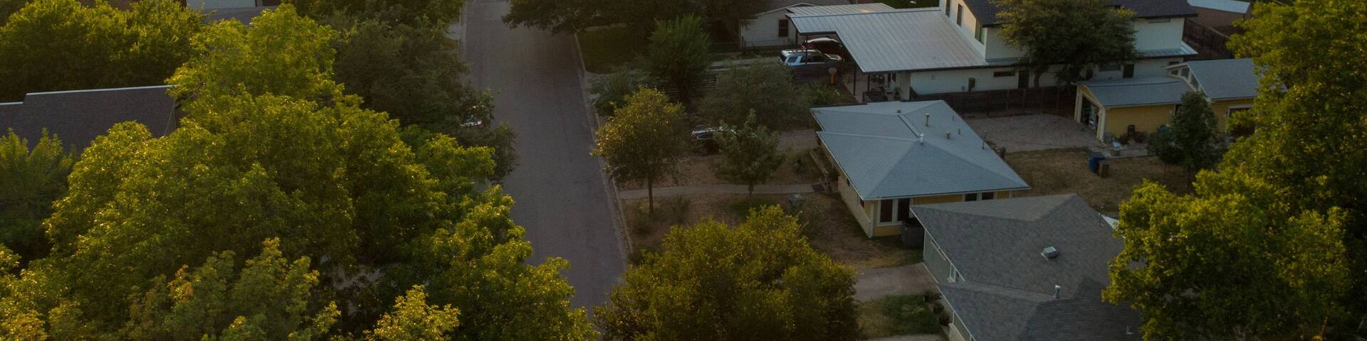 Crestview featuring a sunset, landscape views and a small town or village