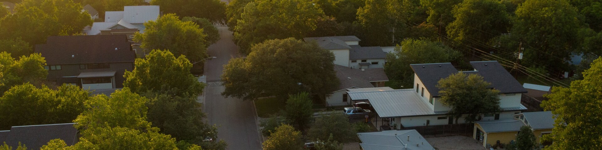 Crestview featuring a sunset, landscape views and a small town or village