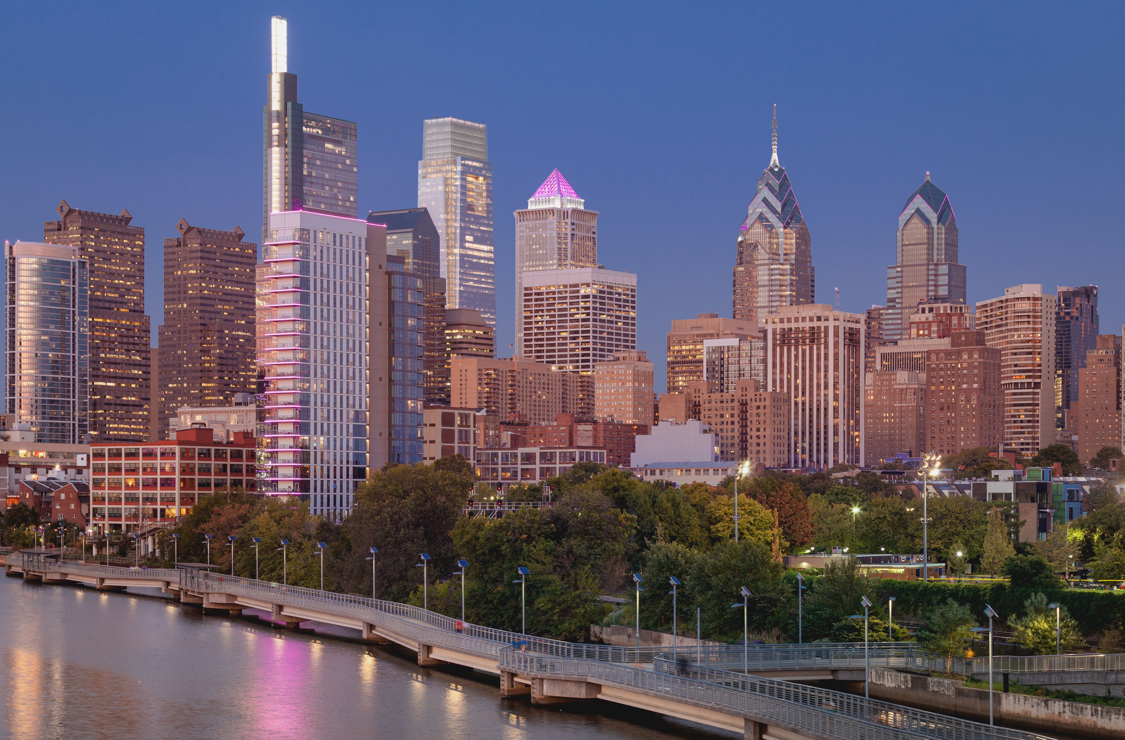 Philadelphia Downtown skyline at Night with the Schuylkill river. Beautiful Sunset Light. Schuylkill River Trail in Background. City skyline glows under the beautiful sunset light. PA, USA.