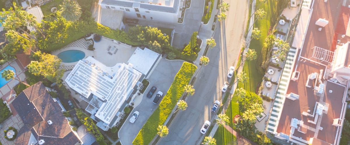 Aerial view of Beverly Hills neighborhood: Sunset Boulevard, North Beverly Drive and Rodeo Drive surrounded with palm trees in Los Angeles, California.