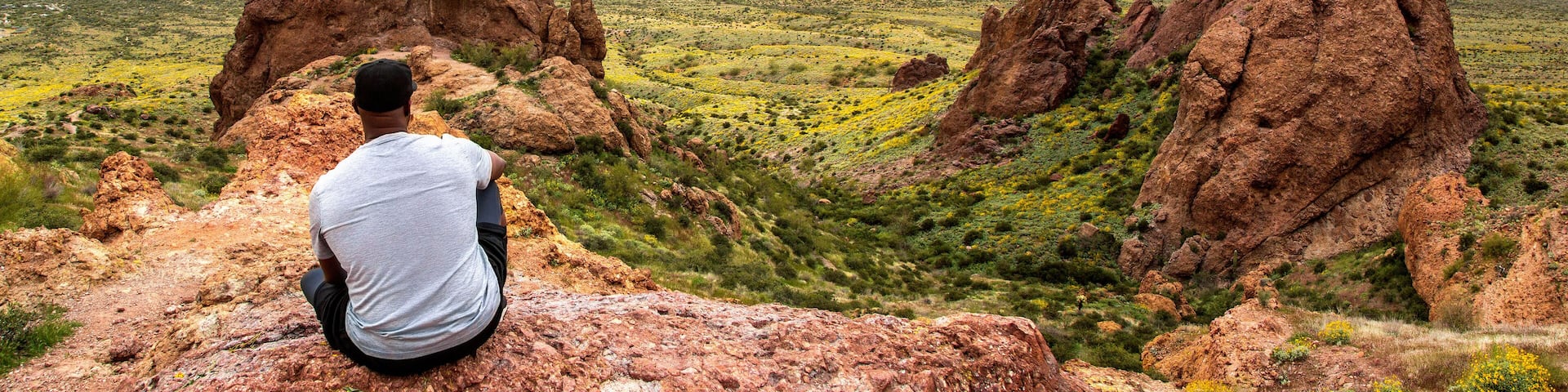 African American Hiker Looking at Arizona Desert from Flatiron Peak Panorama