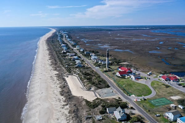 Aerial view of Caswell Beach and lighthouse