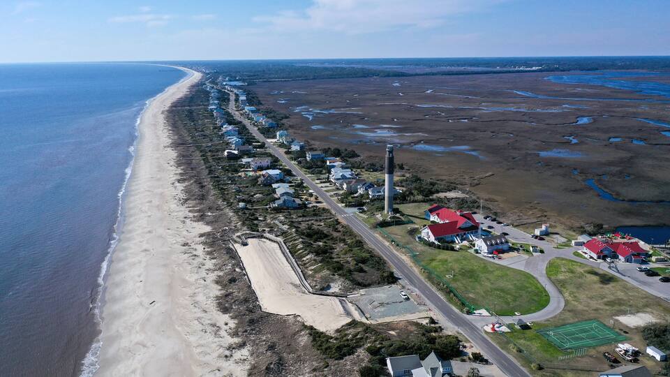 Aerial view of Caswell Beach and lighthouse