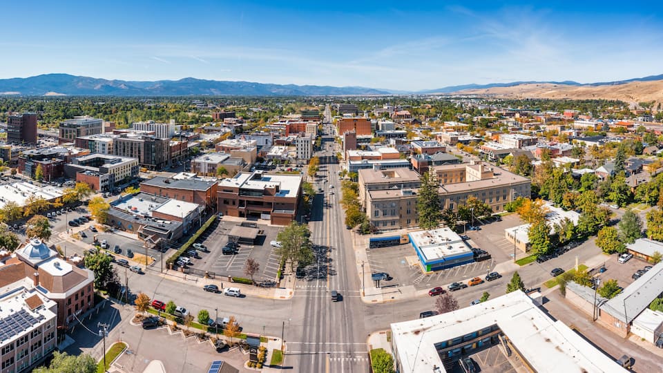 Aerial panorama of Missoula, Montana, along Broadway street. Missoula is a city in and the county seat of Missoula County, Montana. It is located along the Clark Fork River.