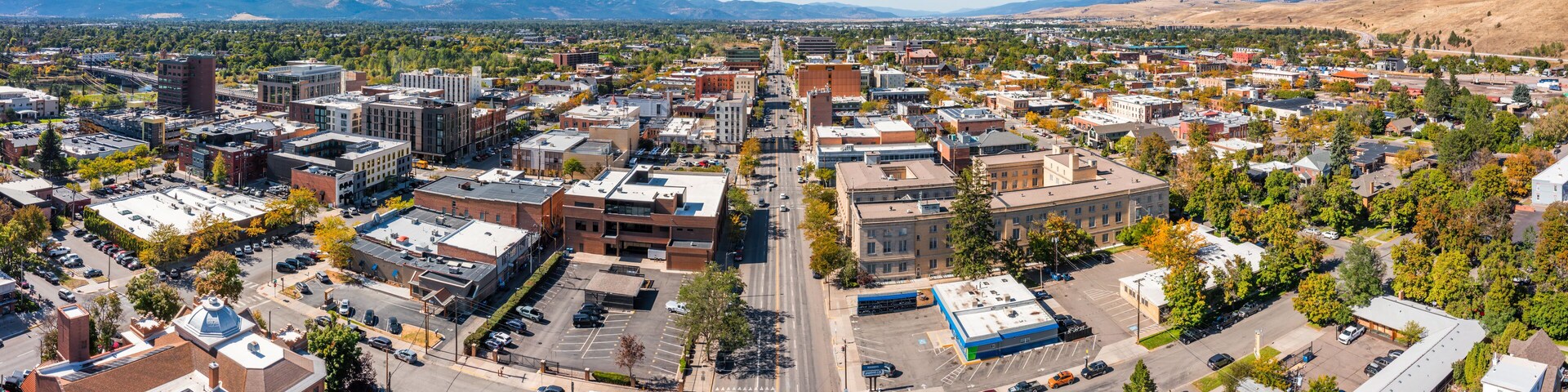 Aerial panorama of Missoula, Montana, along Broadway street. Missoula is a city in and the county seat of Missoula County, Montana. It is located along the Clark Fork River.