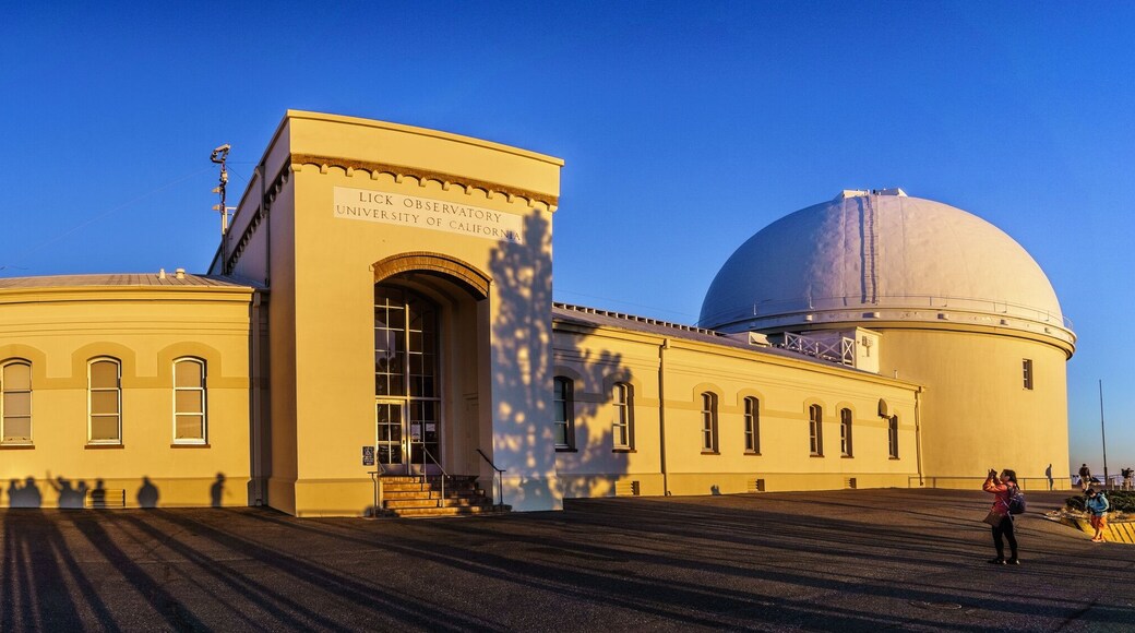 Sunset view of the facade of the historical Lick Observatory; visitors' shadows projected on its walls; San Jose, south San Francisco bay area, California
