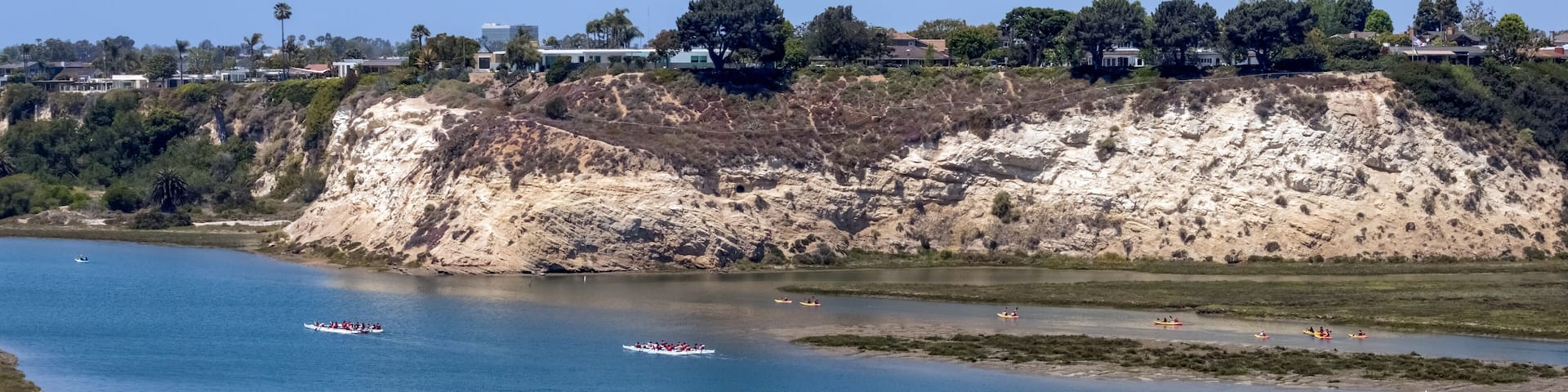 kayaks and canoes on Newport Beach back bay in California on a sunny spring day