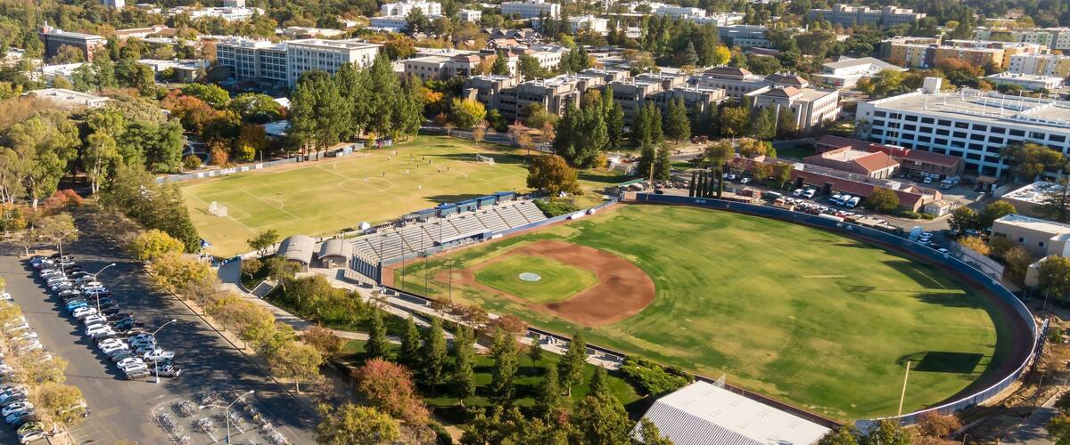 Aerial view of UC Davis campus with a soccer field and baseball diamond. Students and faculty likely enjoying a sunny day on campus. Davis, California, USA