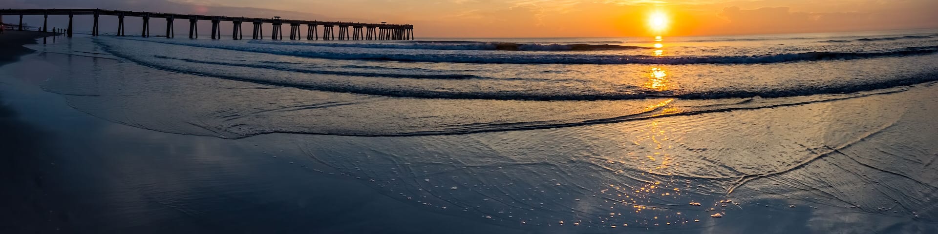 Sunrise over the Atlantic Ocean and the Jacksonville Baech pier in Jacksonville Beach Florida USA