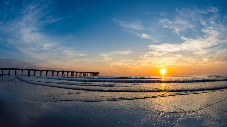 Sunrise over the Atlantic Ocean and the Jacksonville Baech pier in Jacksonville Beach Florida USA