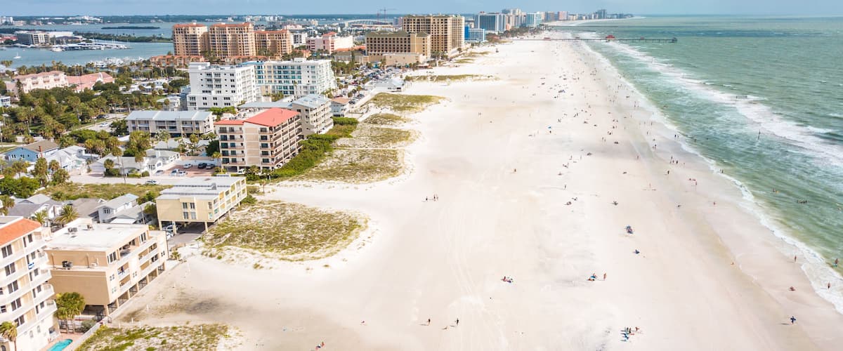 Top the best beaches in the world. Wide and long Ocean beach. Summer or autumn vacation. Location Clearwater beach Florida. American Coast or shore. Island in Gulf of Mexico. Aerial view of city.