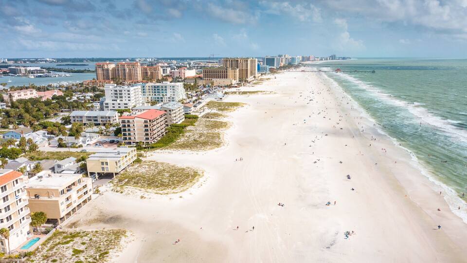 Top the best beaches in the world. Wide and long Ocean beach. Summer or autumn vacation. Location Clearwater beach Florida. American Coast or shore. Island in Gulf of Mexico. Aerial view of city.