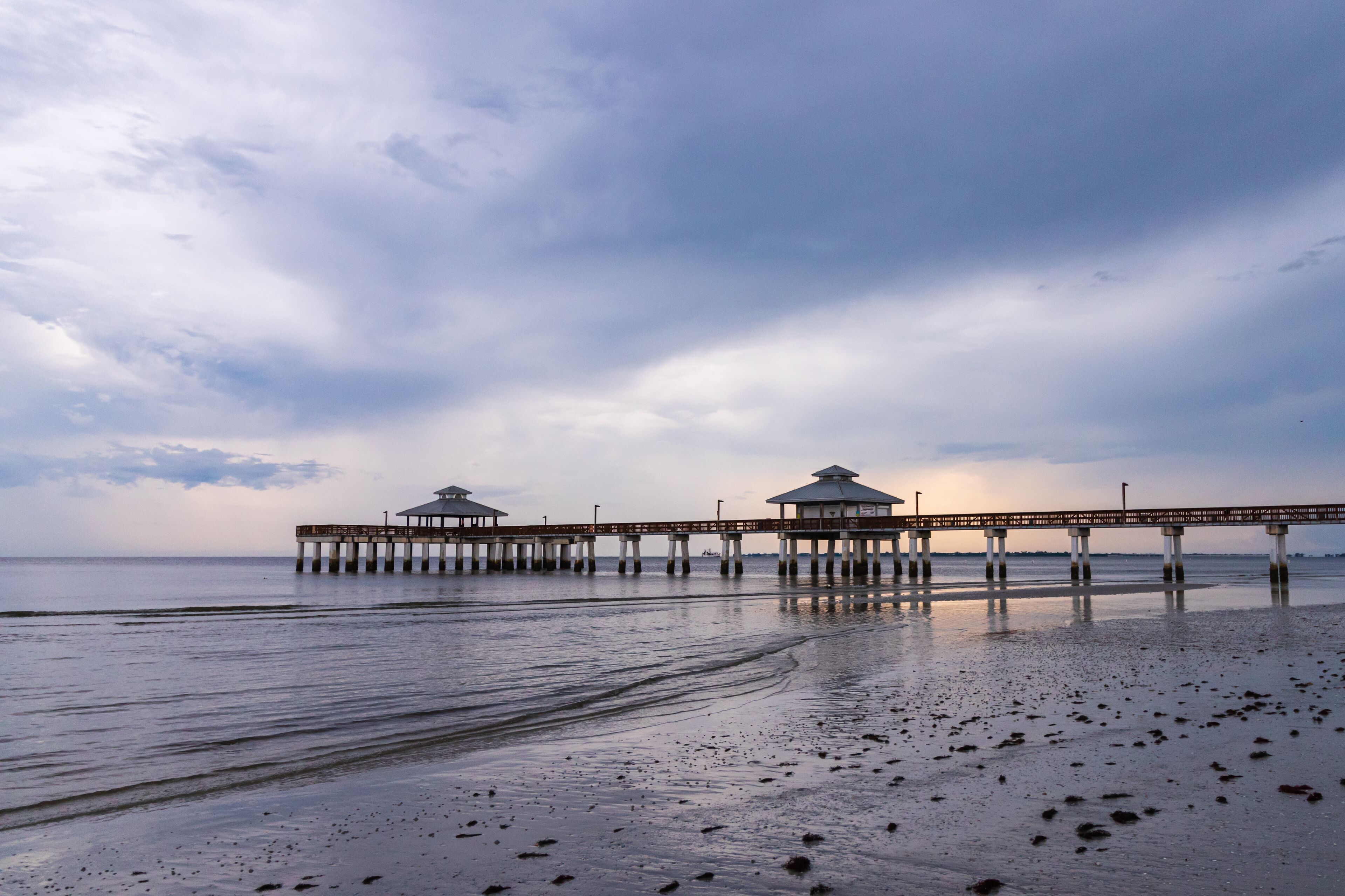  Fishing Pier on a South west Florida Beach during sunset after a storm days before hurricane Dorian calm and relaxing