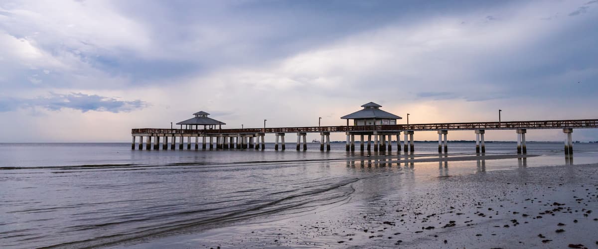 Fishing Pier on a South west Florida Beach during sunset after a storm days before hurricane Dorian calm and relaxing