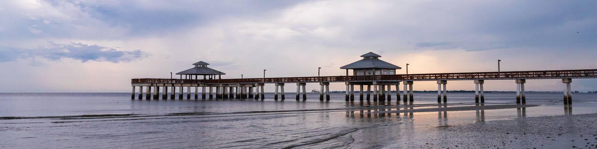 Fishing Pier on a South west Florida Beach during sunset after a storm days before hurricane Dorian calm and relaxing