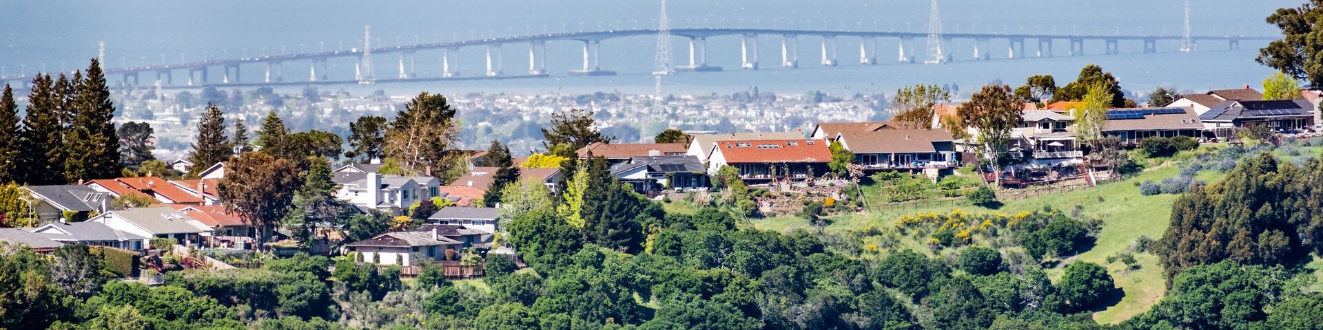 Residential neighborhood on the hills of San Francisco peninsula, Silicon Valley, San Mateo bridge in the background, California