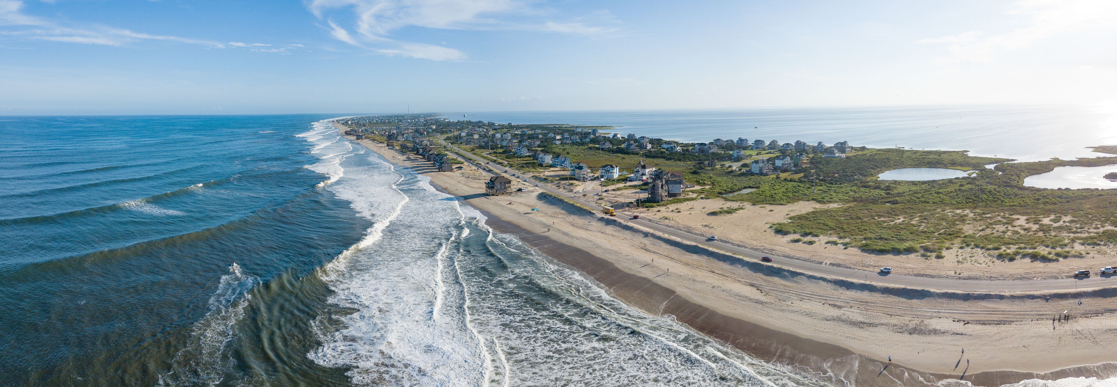 A coastal town with a beach, ocean, and residential areas.