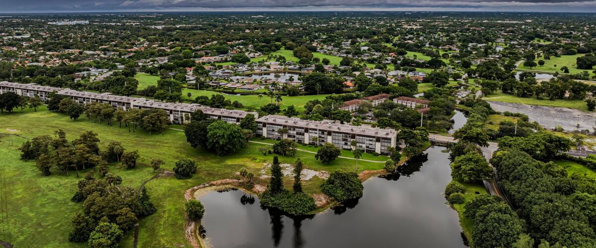 Aerial view of a suburban landscape with lush greenery under a cloudy sky. Lauderhill, Florida